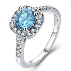 Ring Sea Blue CZ with smaller Crystal CZs Silver Plated